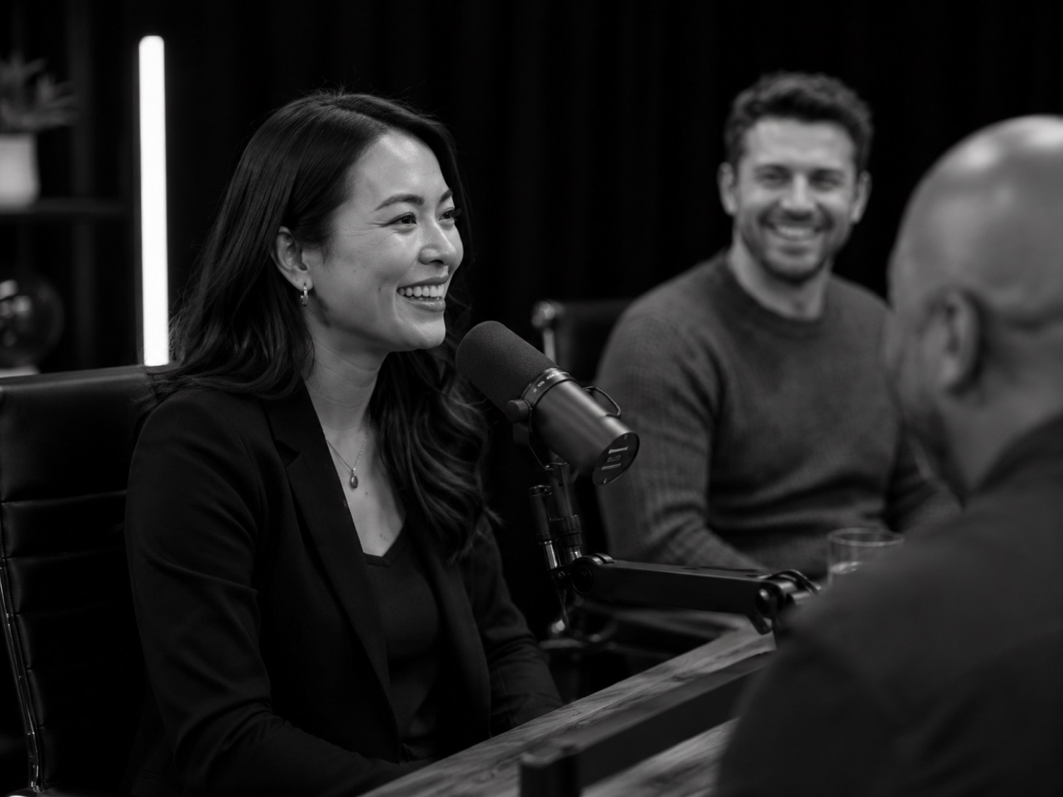 Smiling guest at the mic during a recording at GB Studio