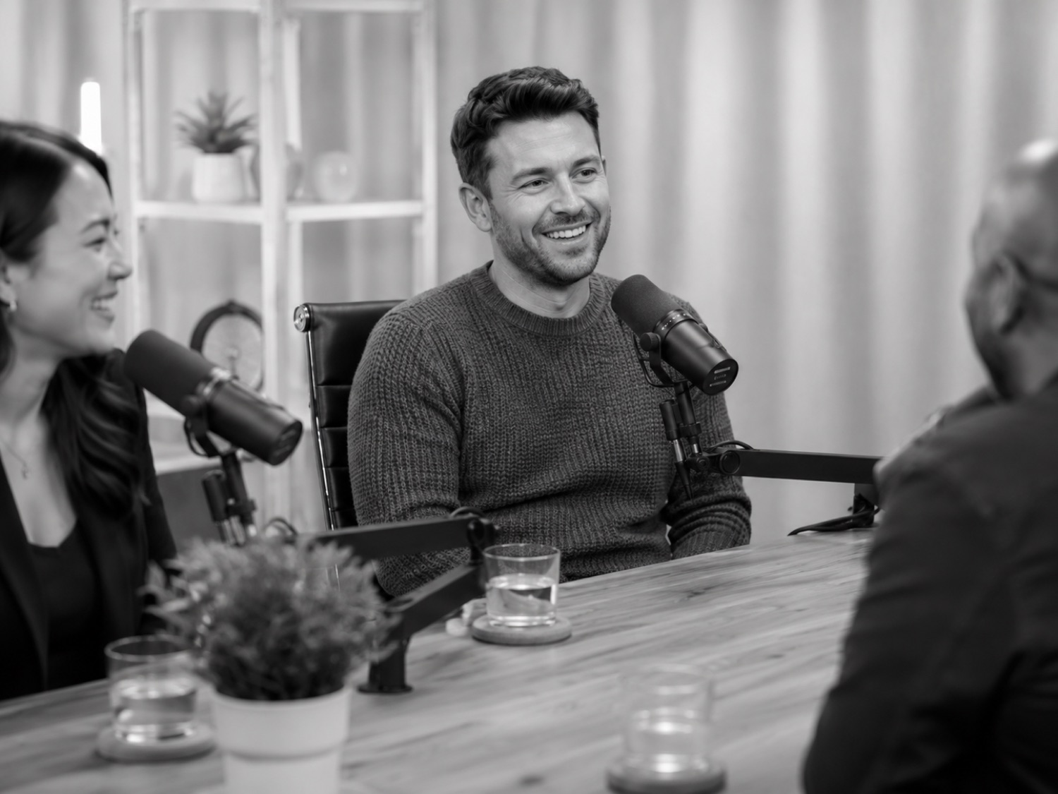 Smiling host at the microphone during a podcast recording at GB Studio